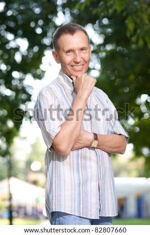 Old man posing for camera in park