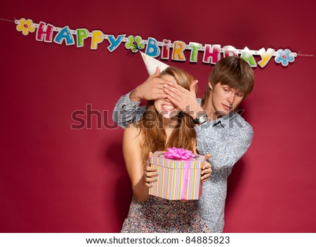 Beautiful girl hold gift with friend at birthday party