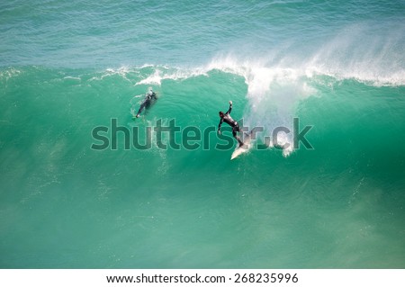 Cape Town, Noordhoek - 29 March 2015: Unknown surfer takes off at well known surf spot known by locals as \