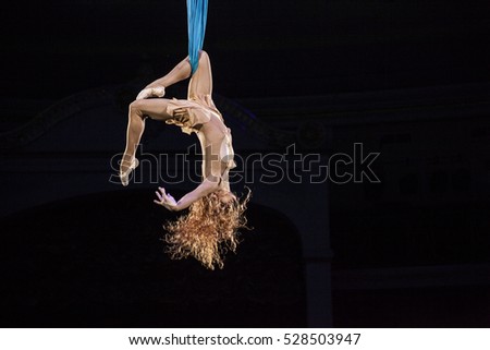 Air gymnast on cloths. Rhapsody of Love. Circus artist. Flying under the big top.