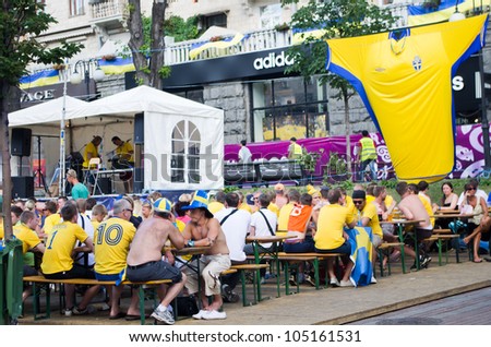 KIEV, UKRAINE - CIRCA JUNE 2012: Swedish football fans relax in the official fan zone of EURO-2012 in the center of Kiev, circa June 2012. EURO 2012 is a European football championship held by UEFA.