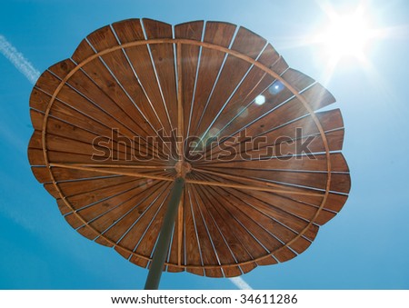 Wooden sun-cover and the sun