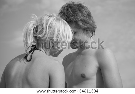 Young couple having a happy silent moment at the beach, black and white