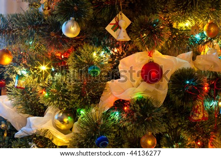 Decorated Christmas tree lit by colored lights