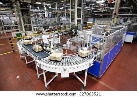 PARMA, ITALY - 3 OCTOBER 2012: Boxes of packaged pasta travelling along the production line inside a pasta factory.