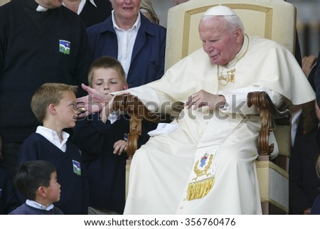 VATICAN CITY, VATICAN - 30 APRIL 2003: Pope John Paul II greets a group of pupils at the end of the weekly general audience in Saint Peter\'s Square at the Vatican.