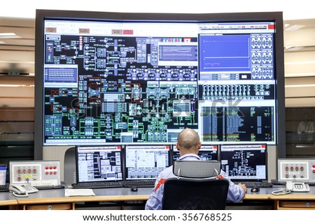 CIVITAVECCHIA, ITALY - 10 OCTOBER 2014: Employees monitoring operational data on computer monitors as they work in the control room at a thermoelectric coal-fired power station.