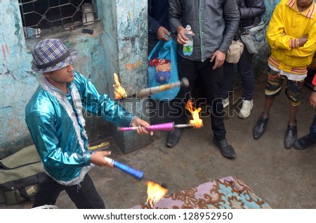 NEW DELHI,INDIA-FEBRUARY, 4: a juggler exhibits him in the greatest slum in New Delhi. 50% of the population of New Delhi is thought to live in slums,on February 4,2013 in New Delhi