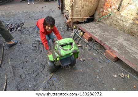 NEW DELHI,INDIA-FEBRUARY 4 :a  unidentified child playing the poorest district of New Delhi in February 4,2013 New Delhi dramatically increases the number of poor people living in slums