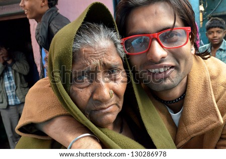NEW DELHI,INDIA-FEBRUARY 4:Portrait of a elderly woman and her grandson in their poor neighborhood in New Delhi in February 4,2013.50% of the population of New Delhi is thought to live in slums