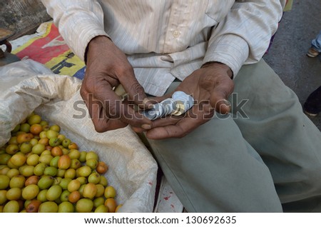 NEW DELHI,INDIA-FEBRUARY 4 : a seller of fruit in a market in New Delhi in February 4,2013. the food market in New Delhi is the largest one in India.