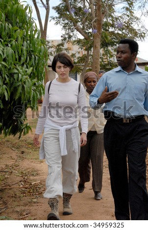 KENYA - CIRCA NOVEMBER 2007: Actress Caterina Murino walks with a guide as she visits local villages where wells were installed by AMREF circa November 2007.