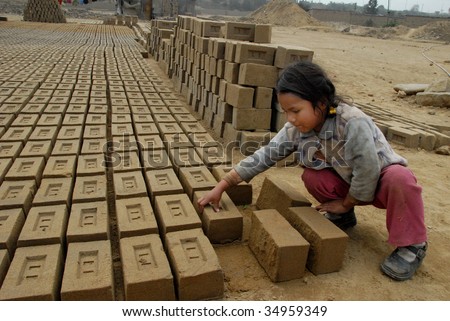 PERU - CIRCA AUGUST 2007: A child laborer works with bricks circa August 2007 in Peru. Brick-making work is a difficult way to earn a living as it is generally low paying.