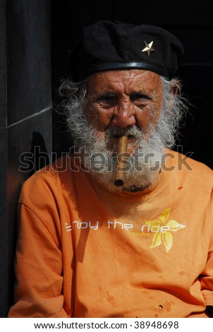 HAVANA - CIRCA FEBRUARY 2009: An unidentified old man smokes a cigar circa February 2009 in Havana. There are many poor elderly in the captial.
