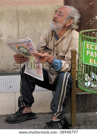 HAVANA- CIRCA FEBRUARY 2009: An unidentifed elderly man reads a newspaper, circa Feb. 2009 in Havana. There are many elderly in the capital.