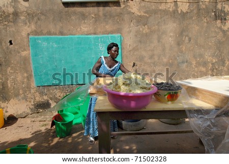OUAGADOUGOU,BURKINA FASO -  MARCH 4: An African woman produces shea butter on March 4, 2005 in Ouagadougou, Burkina Faso. Shea Butter is used in Africa for food and is widely used in cosmetics as a moisturizer.