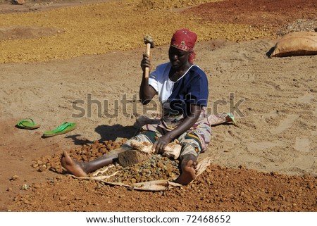 SHINYANGA, TANZANIA-MAR 18: Woman miner quarries stones on March 18, 2010 in Shinyanga, Tanzania. Gravel quarries are sold for a dollar a day. To them it was the only occupation to feed their families