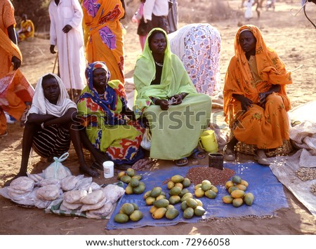NUBA MOUNTAINS,SUDAN - SEPTEMBER 7: women in the market selling papayas on  September 7, 2008 in the Nuba Mountains, Sudan. A small market in the Nuba Mountains run by women
