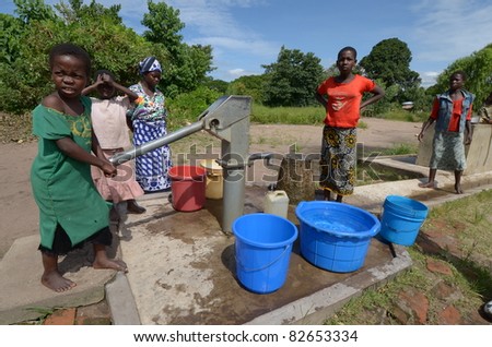 SALIMA, MALAWI-APRIL 10:African unidentified children take water far from their home, in Salima on April 10, 2011.Many children do kilometers on foot and do not attend school to help their family during drought.