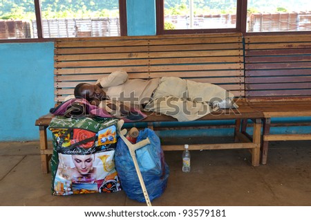 KAPIRI MPOSHI,ZAMBIA–DECEMBER 4: old man sleeping at the station of Tazara the day before catching the train that goes 2 times a week in Kapiri Mposhi ,Zambia December 4,2011