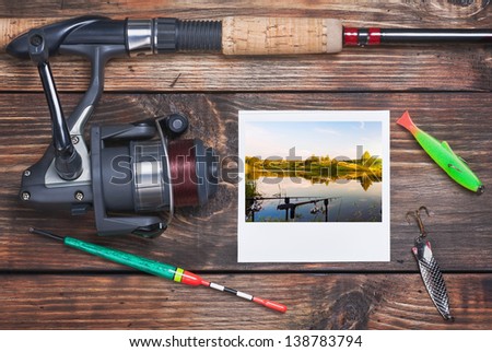 fishing tackle and a photo of successful fishing on the table
