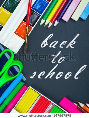 written on the blackboard back to school and supplies for school
