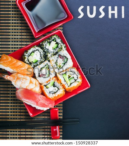 Rolls And Sushi And Chopstick On A Black Background For Tex
