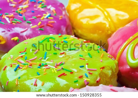Glazed donuts with filling. Focus on the middle of the green donut