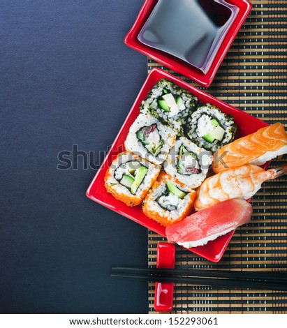 Japanese seafood sushi and chopstick on a black background for text