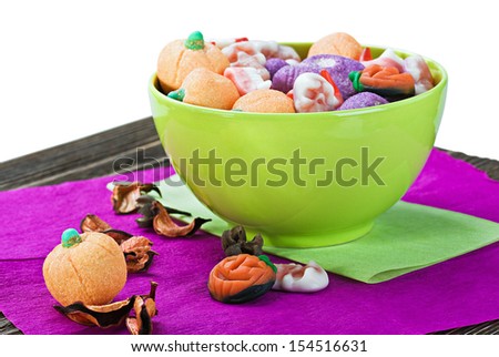 sweets and candies for the holiday Halloween lie on a wooden table