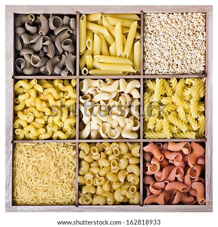 Assortment of Italian pasta in a wooden box on a white background