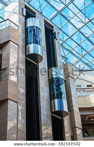 RUSSIA, MOSCOW - MARCH 10, 2014: elevators pulling shoppers between floors in the mall \