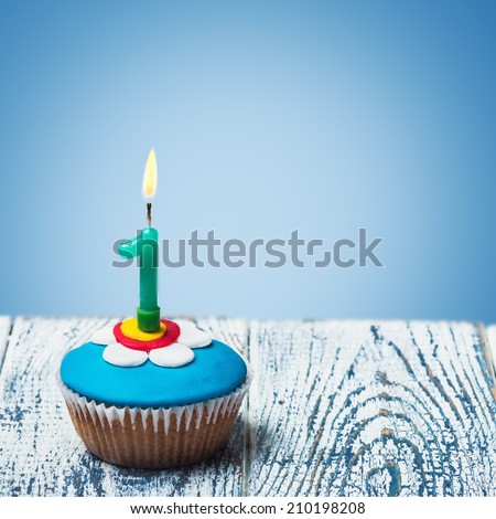 Cupcake with number one on a blue background. birthday greetings
