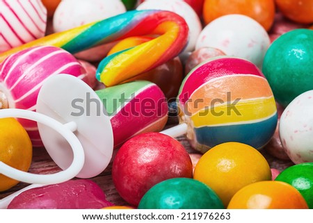 multicolored sweets and chewing gum. Focus on the colored candies, shallow depth of field.