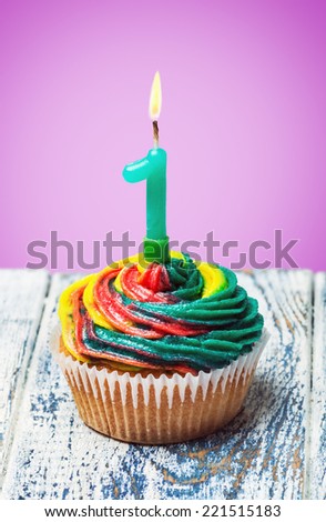 Cupcake with number one on a purple background. birthday greetings