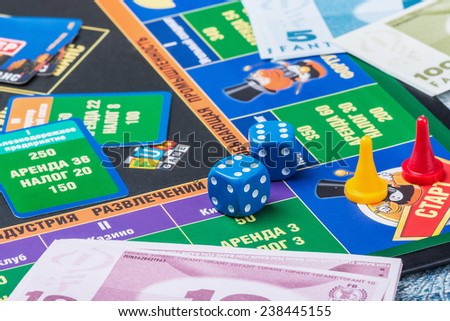 Moscow, Russia - September 11, 2014: Monopoly game on the table. Monopoly game in Russian, a board game in the genre of economic strategy for two or more people.