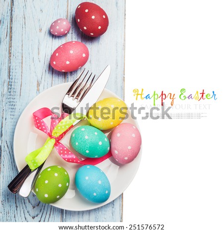 colorful easter eggs and cutlery on a white background. text is an example and removed easily