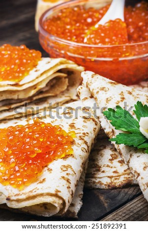 pancakes with red caviar for the holiday merry carnival. Focus on red caviar in the bottom of the frame