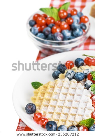 Waffles with fresh berries. Focus on the wafers in the foreground. small depth of field