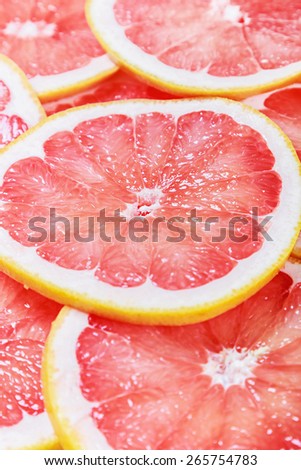 background with citrus-fruit of grapefruit slices. very shallow depth of field, focus in the center of the frame