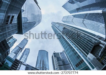 Modern glass silhouettes of skyscrapers in the city. toning photo. Focus on the tops of skyscrapers