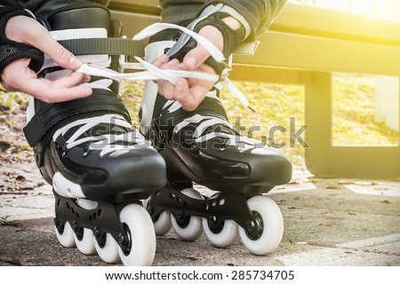 dressing roller skates for skating. focus in the middle of the frame on roller skates