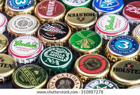 Moscow, Russia - April 28, 2015: Background of beer bottle caps, a mix of various global brands: Grolsch, Bud, Bavaria, Miller, etc.