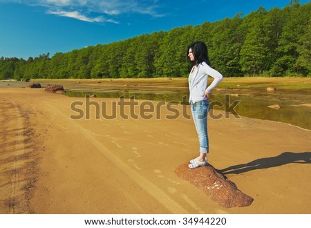 young girl on the shore of the Gulf is looking into the distance