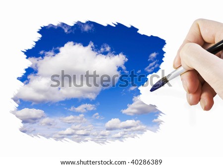 hand with a brush paints a blue sky with clouds