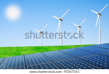 Wind turbines and solar panels in field