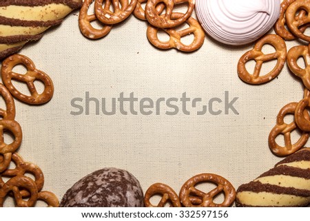 Frame from cookies, gingerbread, marshmallows and pretzel