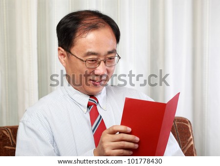 Happy father reading his fathers day card