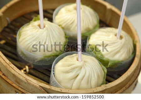 Chinese steamed buns with straws, since these buns are full of hot sup inside.