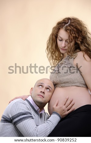 pregnancy concept family studio shot ; love and parenthood